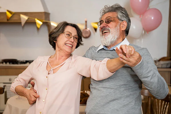 Happy senior couple celebrating safety with Senior Protection medical alert system in Canada