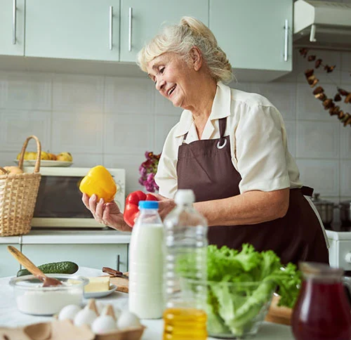 Senior woman in the kitchen being carefree thanks to Senior Protection